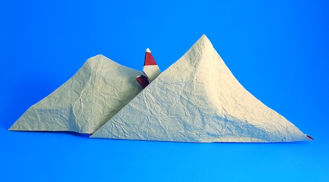 Origami Santa Claus lost in the snowy mountains by Francesco Miglionico. Folded from a square of Crinkle Red scrapbooking paper by Gilad Aharoni on giladorigami.com